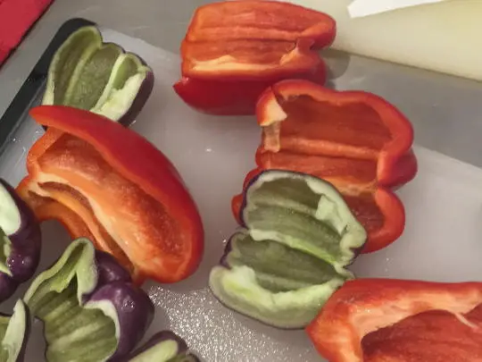 Cut the peppers in half and remove the seeds. Then slice them up.