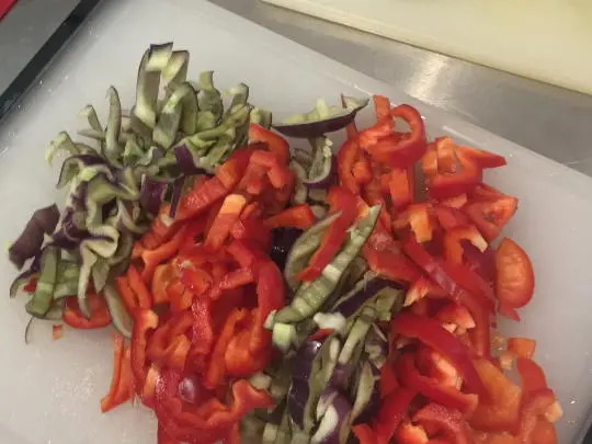 Cut the peppers in half and remove the seeds. Then slice them up.